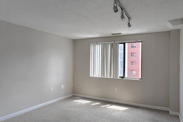 8 9th St Unit 406, Medford, MA 02155 - carpeted spare room featuring track lighting and a textured ceiling
