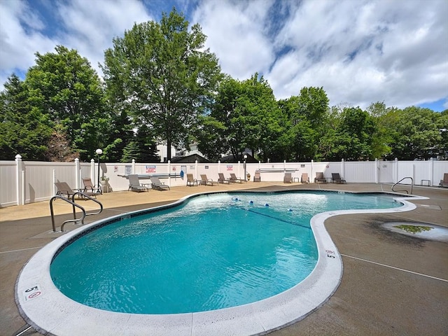 8 9th St Unit 406, Medford, MA 02155 - community pool with a patio area and view of scattered trees