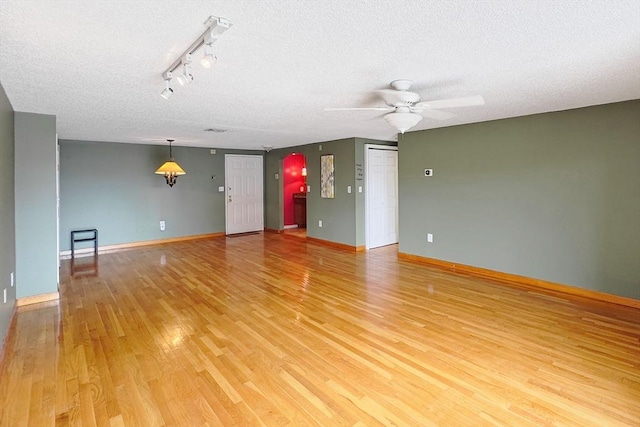 8 9th St Unit 406, Medford, MA 02155 - spare room with light wood-style flooring, a ceiling fan, a textured ceiling, and rail lighting