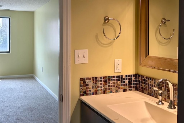 8 9th St Unit 406, Medford, MA 02155 - bathroom with decorative backsplash, a textured ceiling, and vanity