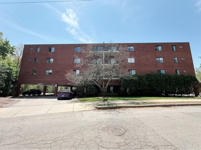 view of building exterior featuring covered parking