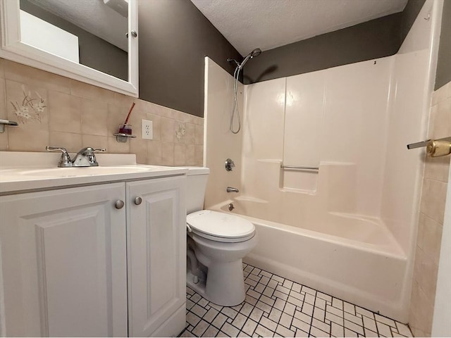 bathroom with toilet, vanity, bathtub / shower combination, tasteful backsplash, and a textured ceiling