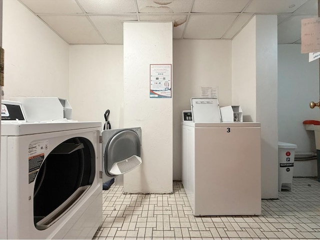 community laundry featuring washer and dryer and light flooring