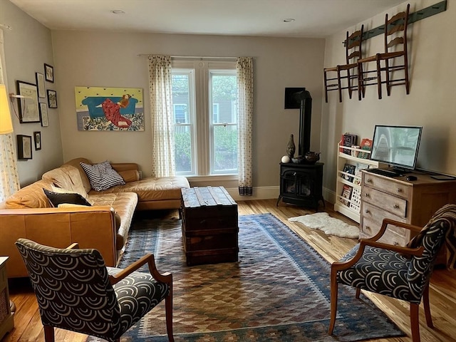 20 Rushmore St Unit 20, Boston, MA 02135 - living room featuring a wood stove, wood finished floors, baseboards, and recessed lighting