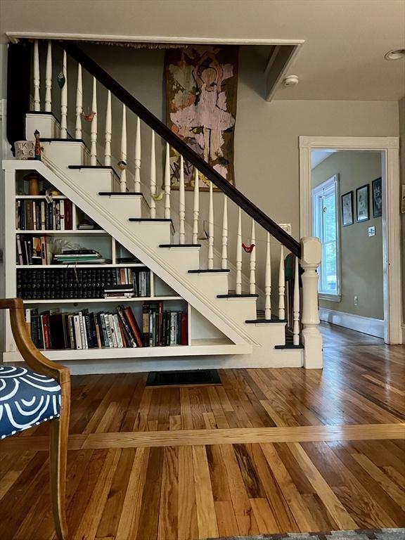 20 Rushmore St Unit 20, Boston, MA 02135 - staircase featuring wood finished floors and baseboards