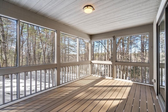 unfurnished sunroom with wooden ceiling and plenty of natural light