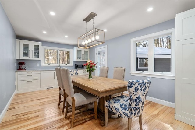 dining room featuring recessed lighting, baseboards, and light wood finished floors