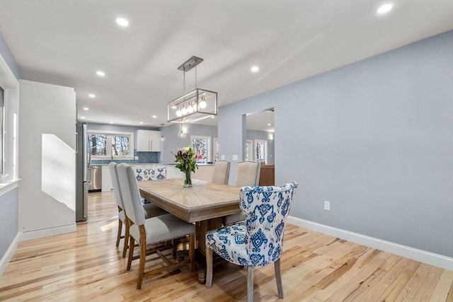 dining room featuring recessed lighting, light wood-style flooring, and baseboards