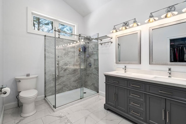 bathroom with toilet, marble finish floor, a sink, and a stall shower