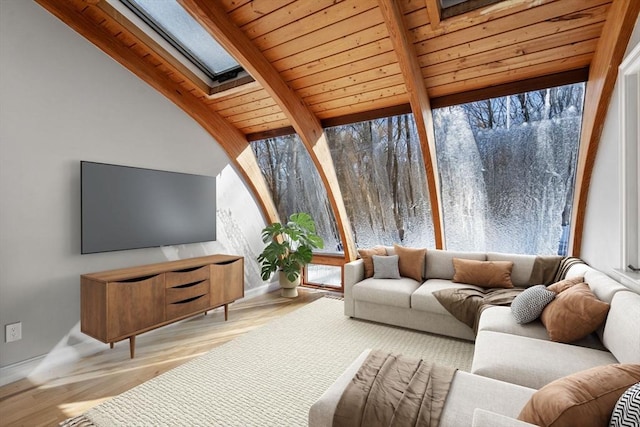 sunroom / solarium with lofted ceiling with skylight and wood ceiling