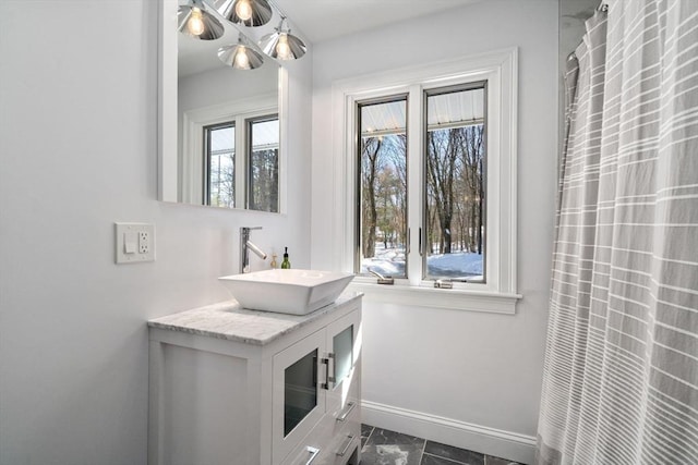 full bathroom with vanity and baseboards