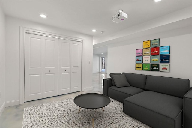 living room featuring recessed lighting, concrete floors, and baseboards