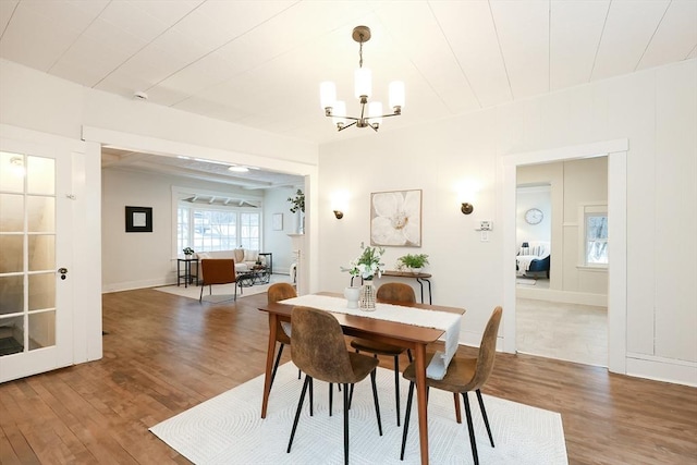 dining area with a notable chandelier and wood-type flooring