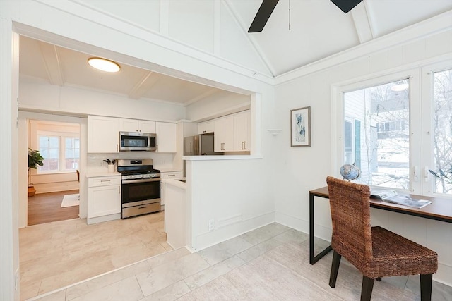 kitchen featuring vaulted ceiling with beams, ceiling fan, white cabinets, and appliances with stainless steel finishes