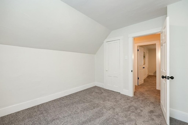 additional living space with vaulted ceiling and light colored carpet