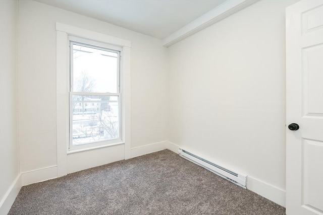 empty room with a baseboard heating unit, plenty of natural light, and carpet