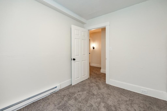 carpeted empty room with a baseboard heating unit