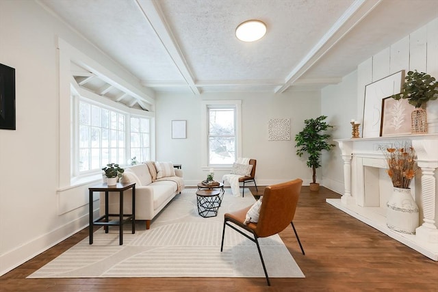 living room featuring hardwood / wood-style flooring, coffered ceiling, a textured ceiling, and beamed ceiling