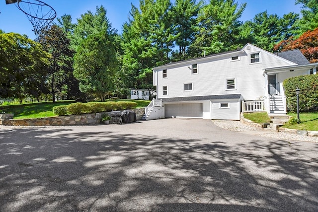 view of side of property featuring a yard and a garage