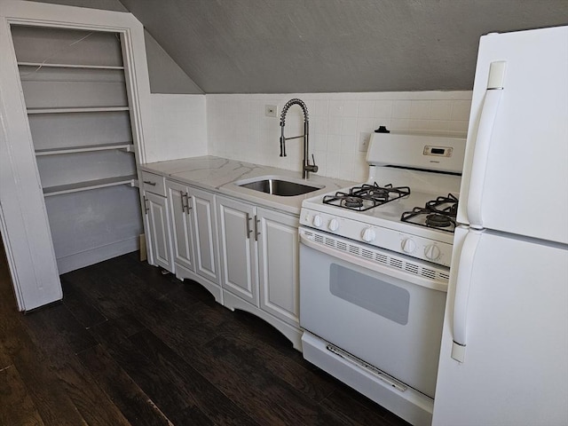 kitchen with tasteful backsplash, dark wood-type flooring, white appliances, white cabinetry, and a sink