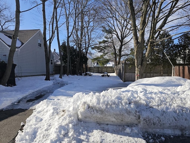 snowy yard with fence