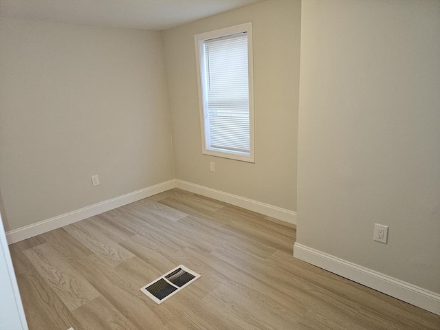 unfurnished room with visible vents, baseboards, and light wood finished floors