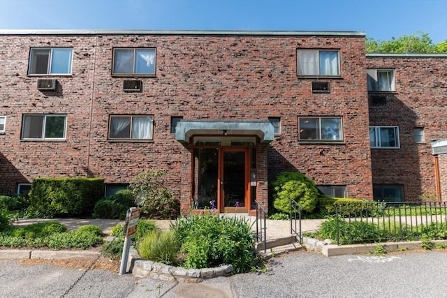 57 Saint Paul St Unit 19, Brookline, MA 02445 - view of front of property featuring brick siding and fence