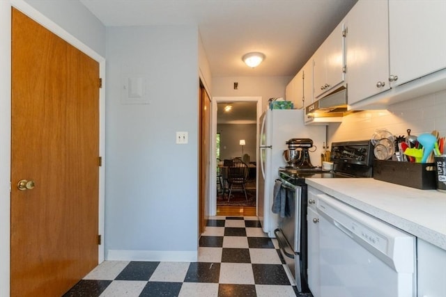 57 Saint Paul St Unit 19, Brookline, MA 02445 - kitchen with white appliances, dark flooring, under cabinet range hood, light countertops, and white cabinets