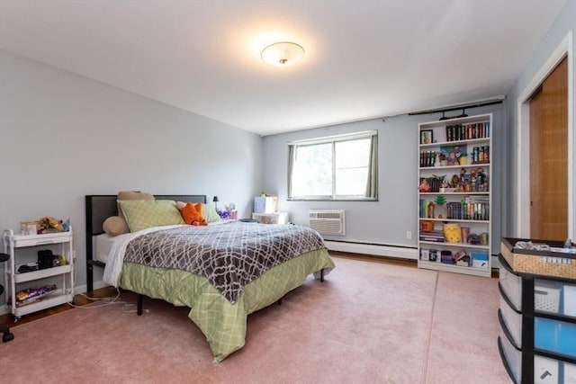 57 Saint Paul St Unit 19, Brookline, MA 02445 - bedroom featuring a baseboard radiator, a wall unit AC, and carpet floors