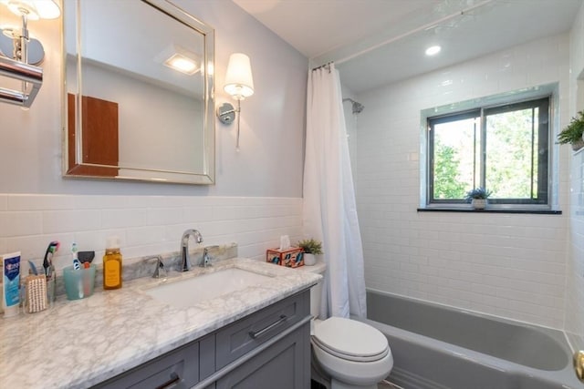 57 Saint Paul St Unit 19, Brookline, MA 02445 - full bath with toilet, vanity, tile walls, shower / bath combination with curtain, and a wainscoted wall