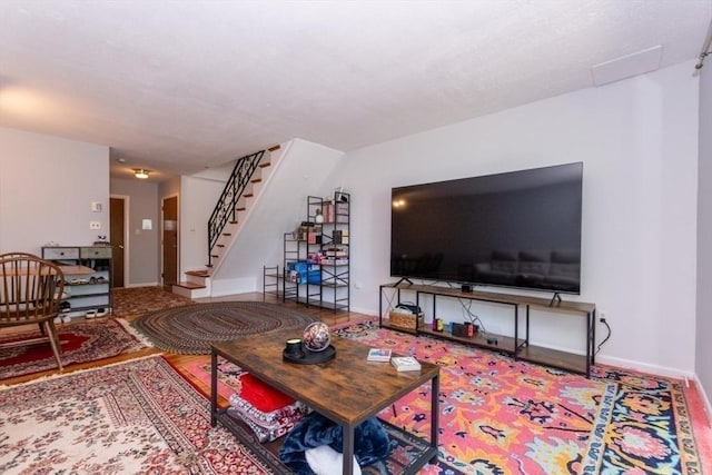57 Saint Paul St Unit 19, Brookline, MA 02445 - living room featuring stairway and baseboards