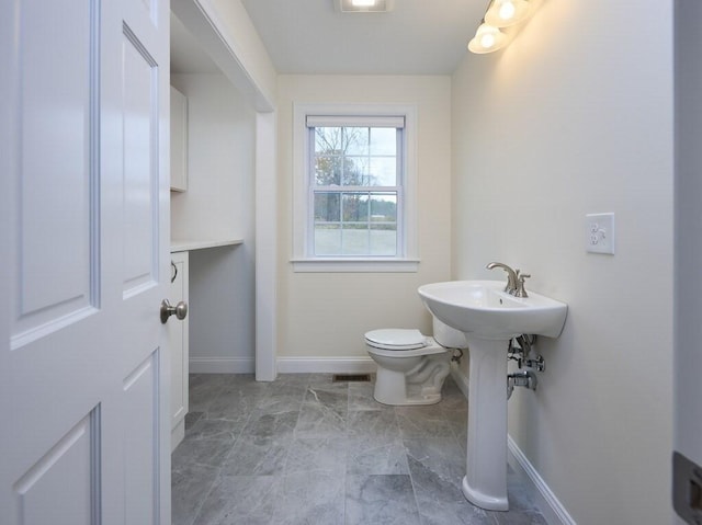 70 Kilburn St, Lunenburg, MA 01462 - bathroom with baseboards, toilet, and marble look tile flooring
