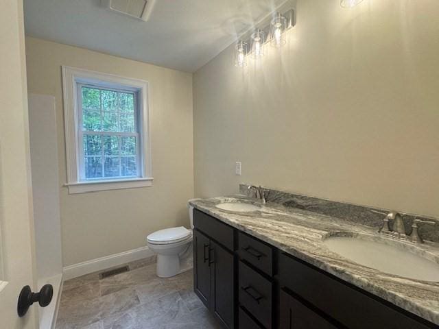 70 Kilburn St, Lunenburg, MA 01462 - full bath with double vanity, toilet, and baseboards
