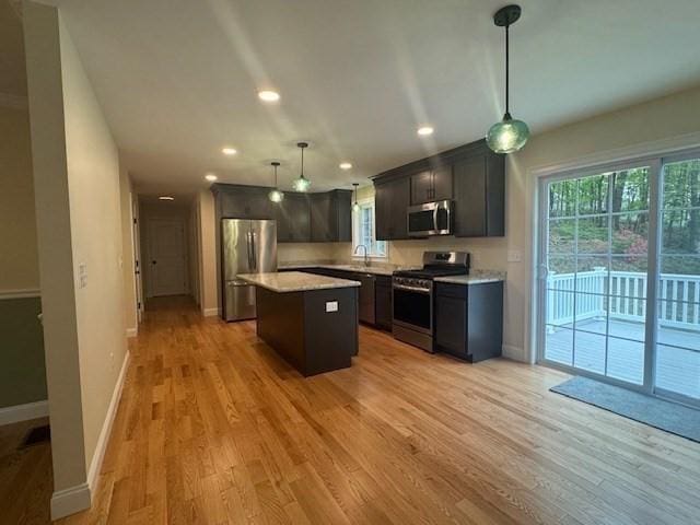 70 Kilburn St, Lunenburg, MA 01462 - kitchen featuring appliances with stainless steel finishes, a sink, baseboards, light wood finished floors, and light countertops