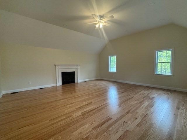 70 Kilburn St, Lunenburg, MA 01462 - bonus room featuring lofted ceiling, a ceiling fan, wood finished floors, a fireplace, and baseboards