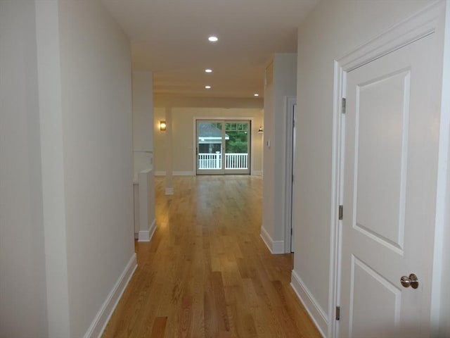 corridor with light hardwood / wood-style flooring