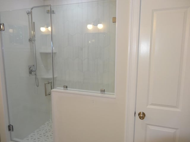 bathroom with a shower with door