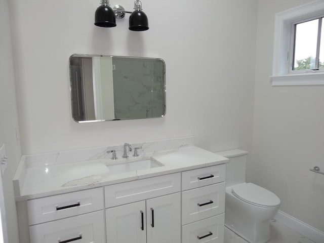 bathroom featuring walk in shower, vanity, and toilet