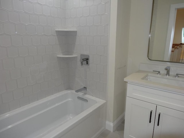 bathroom with tiled shower / bath combo and vanity