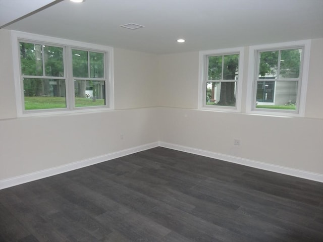 unfurnished room with dark wood-type flooring