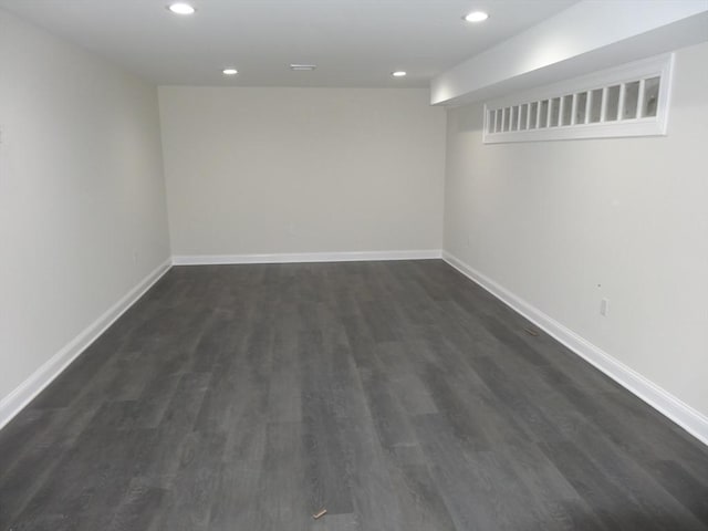 basement featuring dark hardwood / wood-style flooring