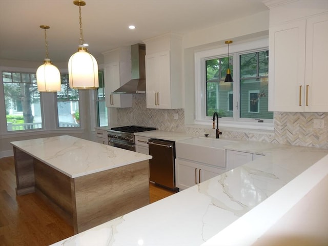 kitchen with a kitchen island, white cabinetry, dishwasher, light stone countertops, and wall chimney exhaust hood