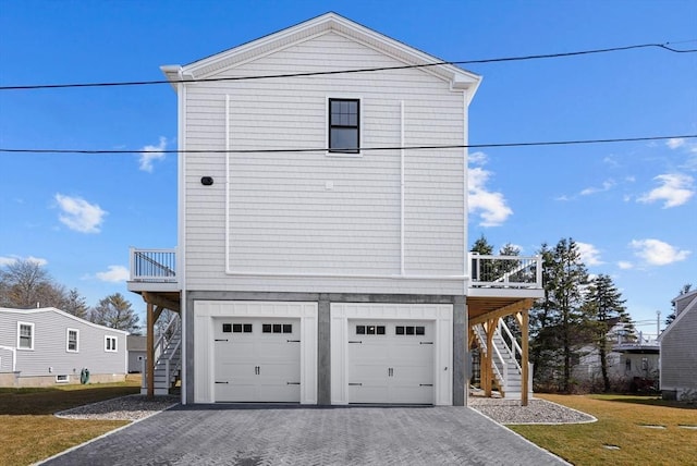 view of property exterior featuring a garage and a lawn