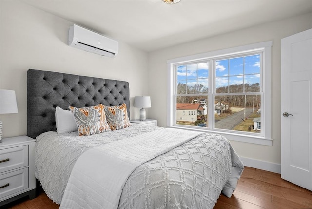 bedroom featuring dark hardwood / wood-style floors and an AC wall unit