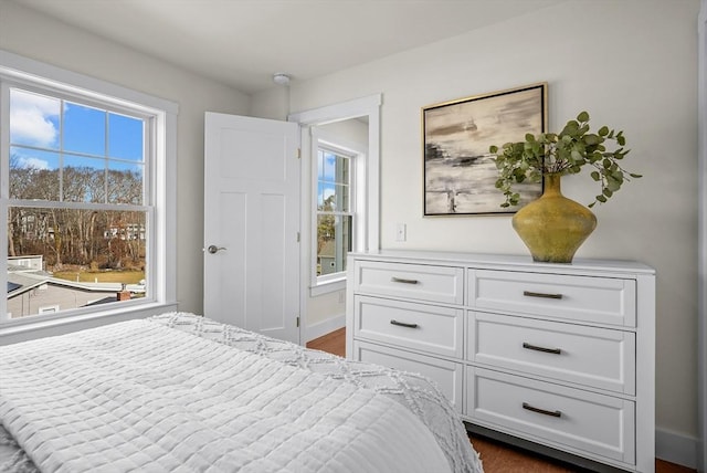 bedroom with dark hardwood / wood-style flooring