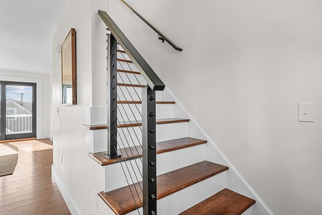 staircase with wood-type flooring