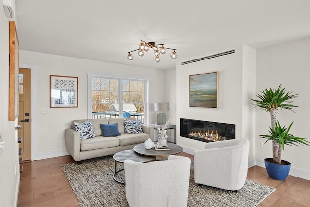 living room with hardwood / wood-style flooring and an inviting chandelier