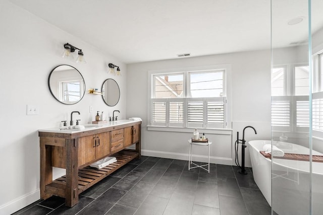 77 Lighthouse Rd, Scituate, MA 02066 - bathroom with plenty of natural light, a soaking tub, double vanity, and baseboards