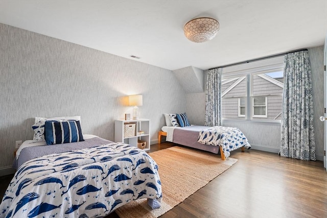 77 Lighthouse Rd, Scituate, MA 02066 - bedroom featuring wallpapered walls, wood finished floors, and baseboards