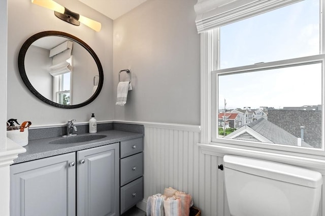 77 Lighthouse Rd, Scituate, MA 02066 - half bathroom with a wainscoted wall, toilet, and vanity